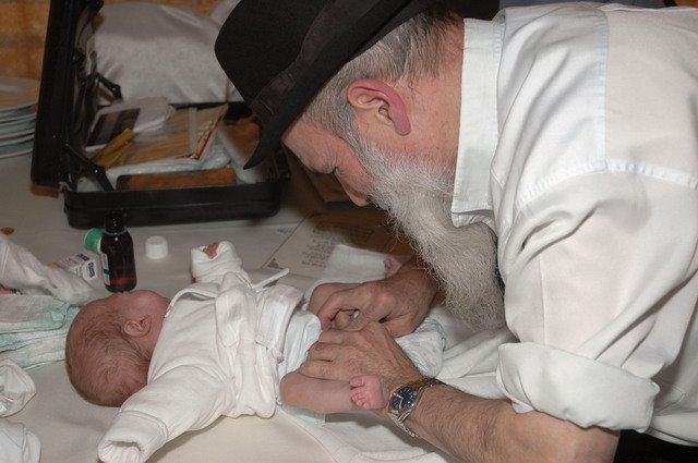 Mohel carves his religion into the flesh of an infant, permanently altering his body through genital mutilation.