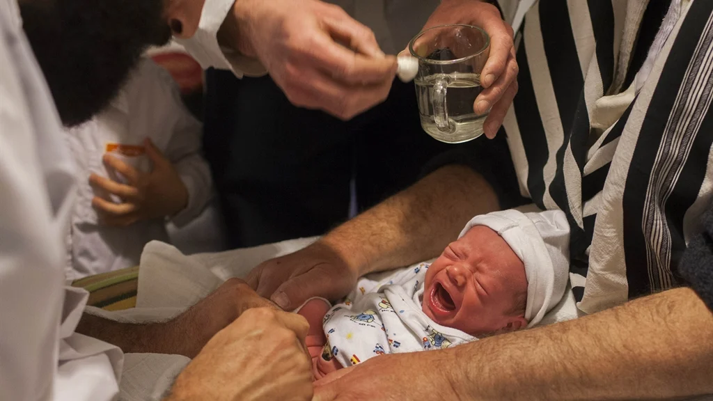 Baby boy cries profusely as predators genitally mutilate him.